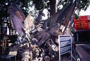 An untouched Mig-21 stands at the entrance. The museum's yard is piled with the wreckage of B52s, Q2Cs and B52s -- the metal still shines deadly even if it has been dulled by the patina of time. Copyright Victoria Brooks.