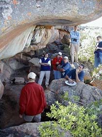 Small groups of no more than 8 visitors listen as the ranger explains the origin and techniques used at a thousand year old site. � Rick Hudson.