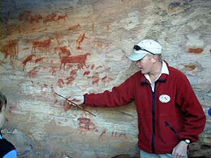 Reserve ranger explains aspects of Bushman paintings. The rangers never touch the paintings with theirs hands, part of the on-going protection program. � Rick Hudson.