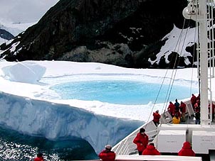 The boat inches up to an icy Antarctic pond. Copyright: Cynthia Boal Janssens.
