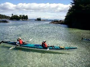 A double kayak navigates the placid waters of the Lost Islands. Copyright Rick Hudson.