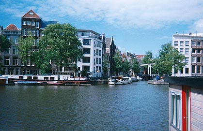 Amsterdam�'s placid canals, with their houseboats, are a contrast to the crush of the red-light district. Copyright Tyson Brooks.