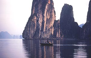 The sheer cliff faces of Halong Bay loom dramatically from the water. Copyright: Victoria Brooks.