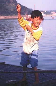 A playful boy apes for the camera. Copyright: Victoria Brooks.