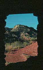 View of Palo Duro Canyon framed by an open window in old stone shelter. Copyright: Kathryn Means, 1999