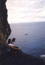 View from inside Christian�s Cave, Eliza (left) and her friend far above the ocean and their sailing ship Concordia. Credit: Photo � by Eliza Priest 