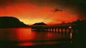 Watching a beautiful sunset, such as this one at Hanalei Pier, provides visitors another way to relax in the beauty of Kauai. Courtesy of the Kaua'i Visitors Bureau.