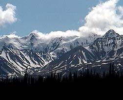Courtesy of Tincup Wilderness Resort, Yukon. Clouds roll over the snowy mountains of Yukon�s Kluane National Park.