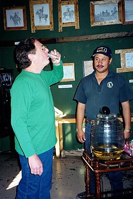Willing to try anything, Paul Ross samples a supposedly therapeutic sip of rattlesnake sotol. Copyright: Kathryn Means.