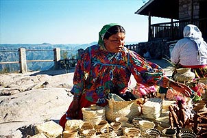 A Raramuri woman sells handmade crafts at the Divisadero overlook above the Copper Canyon. Copyright: Kathryn Means.