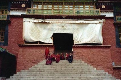 Monks gather on the monastery's steps. Copyright: Lucy Moss.