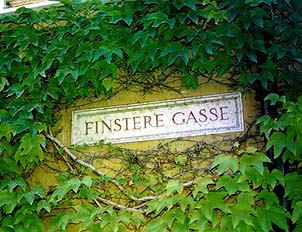 Ivy nearly covers an etched street sign in the old city. Copyright: Jim Johnson.