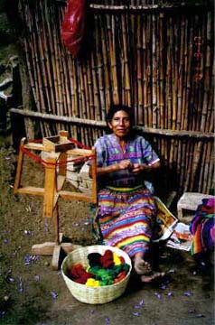 Lidias mother winds a ball of thread. The weaving tradition is earned at an early and is handed down from generation to generation. Copyright: Kennerley Clay.