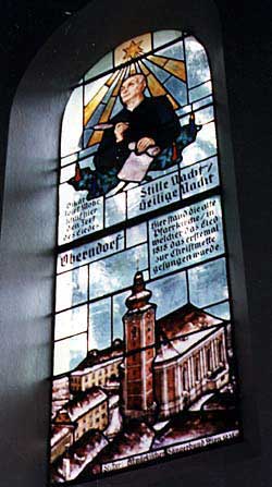 A stained glass window in the Silent Night Memorial Chapel in Oberndorf shows the old church and a depiction of Josef Mohr. Copyright Jim Johnson.