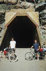 Our bikes laden with 80 lbs of gear, we take a break at one of the many tunnels in Myra Canyon. � Tyson Brooks