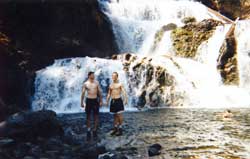 Showering with shoes under the icy falls. Copyright: Brian Southby, 1999.